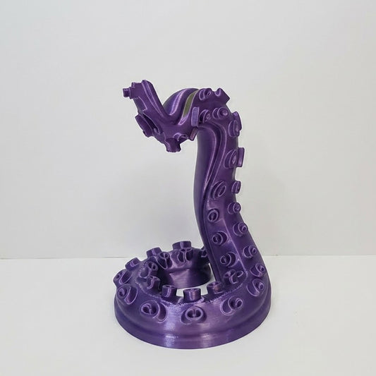 Purple dragon-like sculpture on a white background