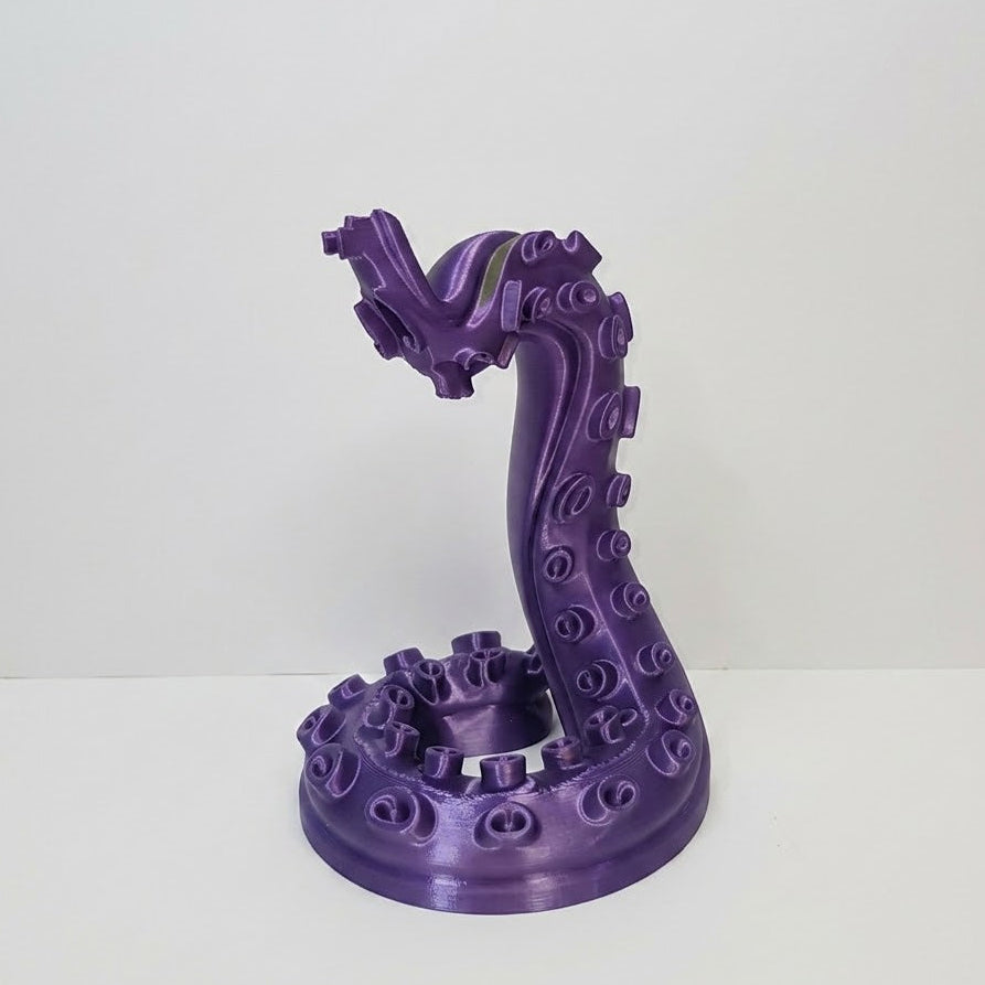 Purple dragon-like sculpture on a white background