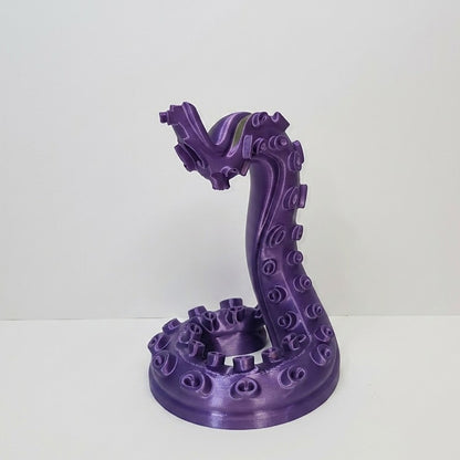 Purple dragon-like sculpture on a white background