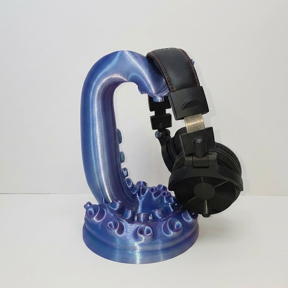 Blue and black suction cup holder on a white background