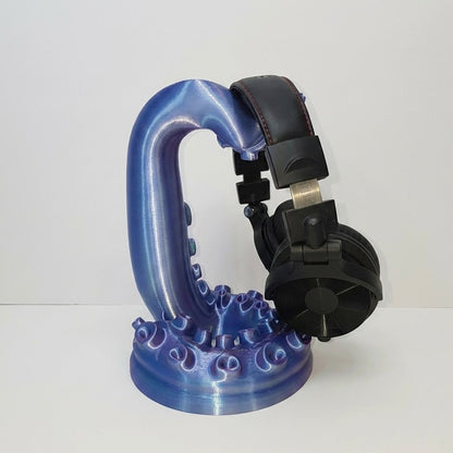 Blue and black suction cup holder on a white background